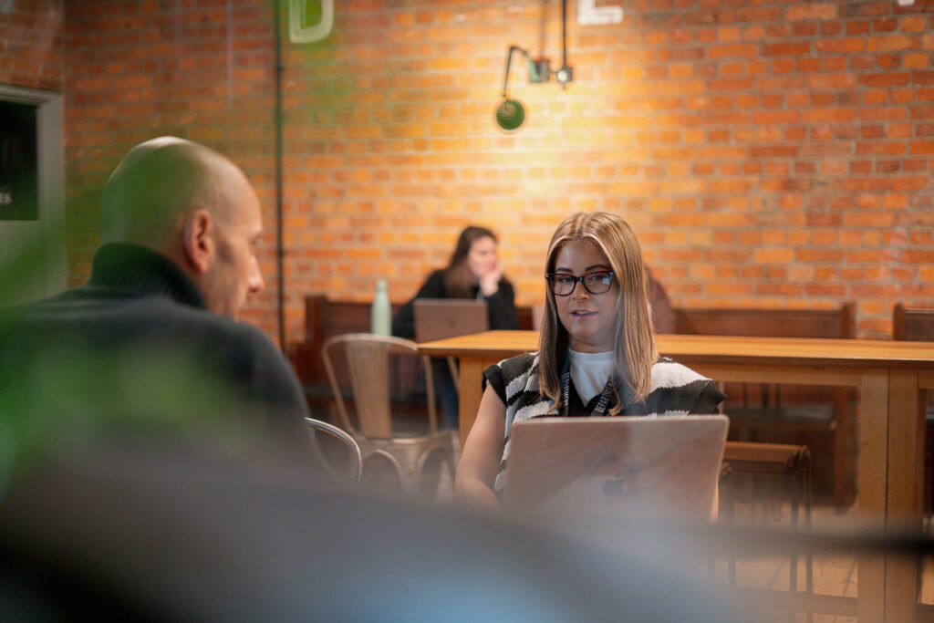 Man and lady having a meeting in a coffee shop