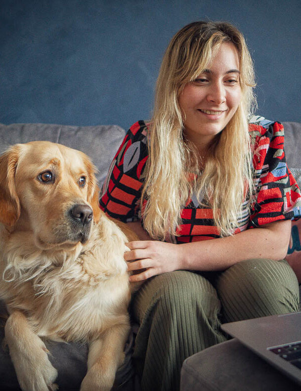 Lady on sofa with dog working from home