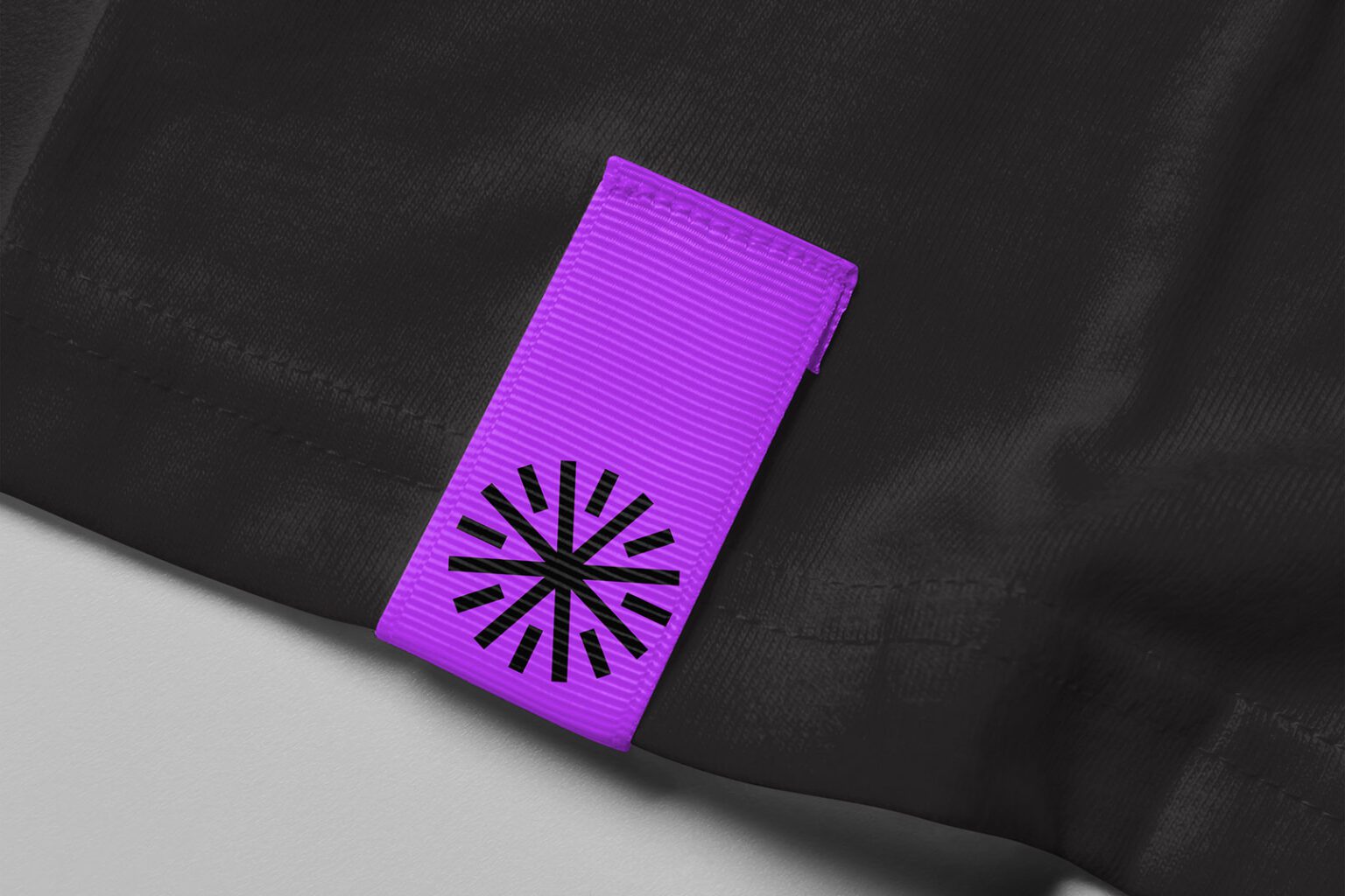 A branded lapel with logo on a black t-shirt.