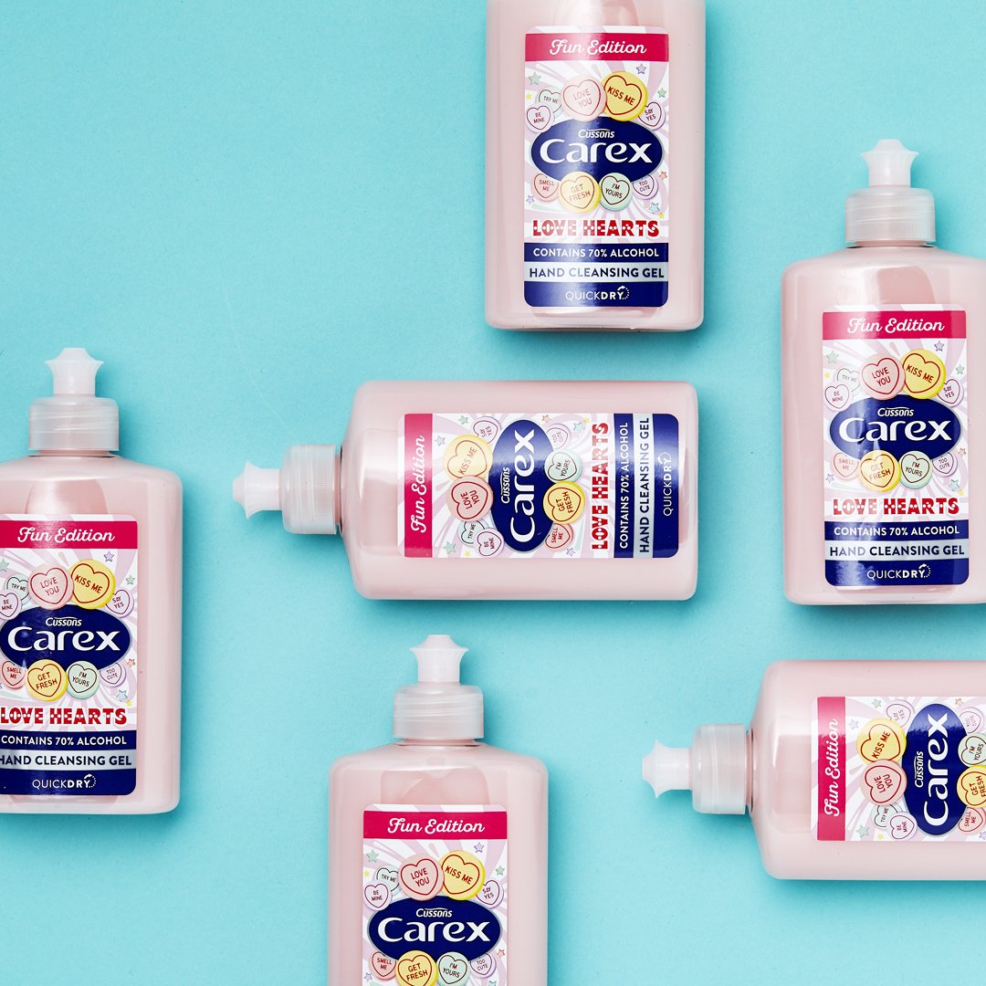 Carex Love Hearts mini hand sanitisers on blue background.
