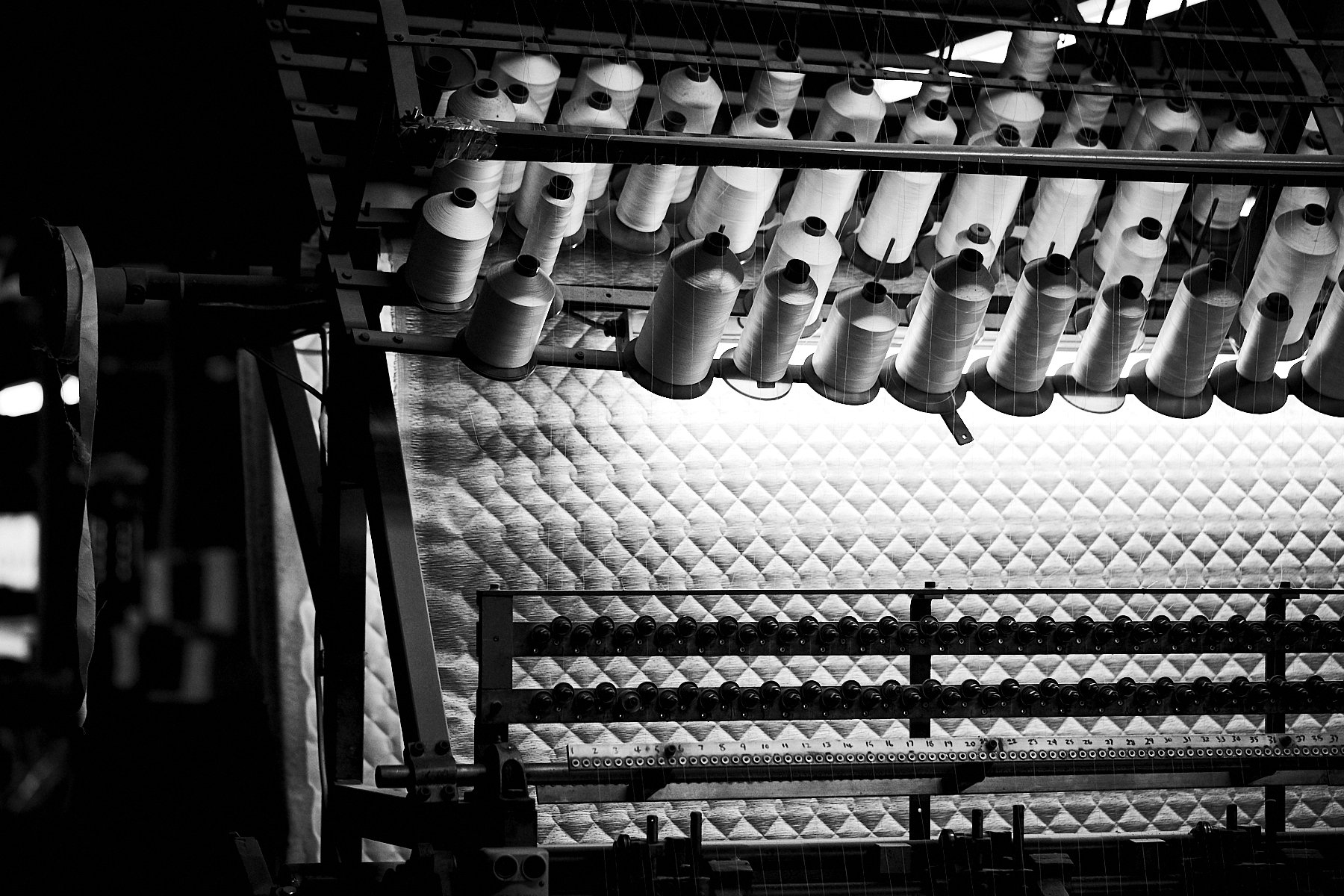 Abstract photography of spools in a mattress factory.
