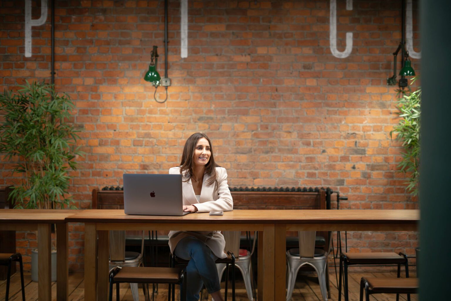 Candid shot of businesswoman with laptop in cafe