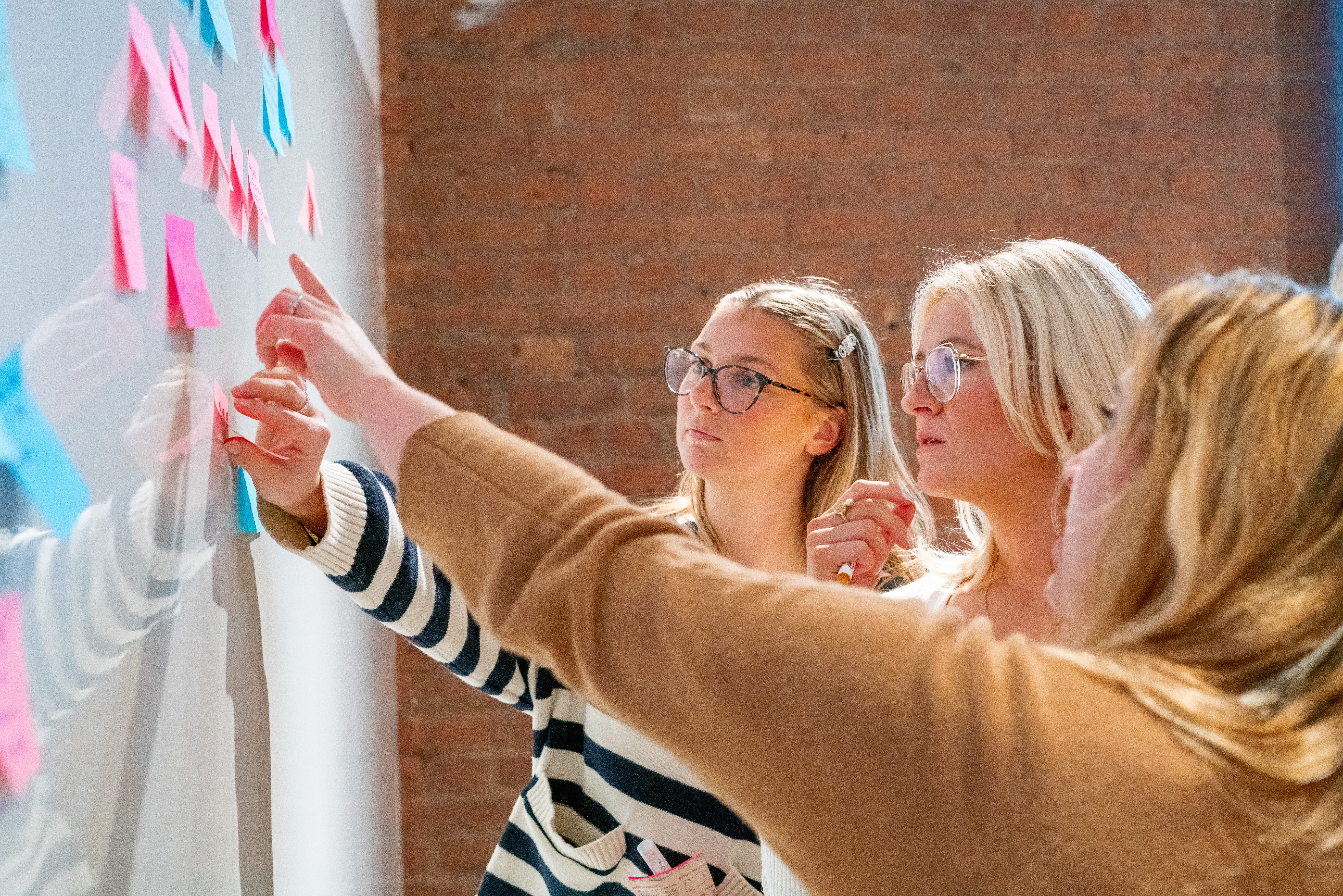 Colleagues collaborating over an ideas board